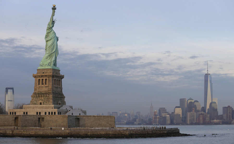 The Statue of Liberty looks out on the lower Manhattan skyline, January 2014. (AP)  