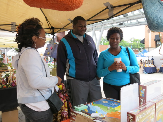 Paulette Mpouma show The Africa Memory game to potential buyers at the Farmers Market in Silver Spring, Maryland. (Photo by Rosanne Skirble/VOA) 