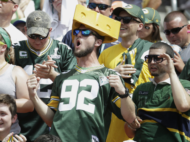 Green Bay Packers fans cheer during an NFL football game against the Miami Dolphins, Oct. 12, 2014, in Miami Gardens, Fla. (AP Photo)