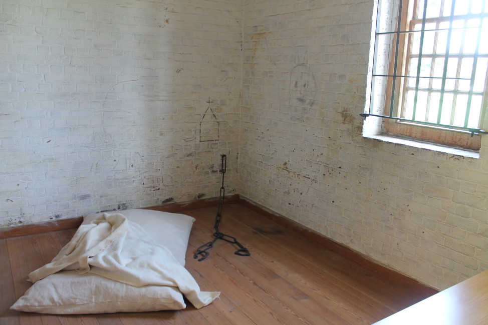 Recreation of a 1773 patient cell at the Public Hospital for Persons of Insane and Disordered Minds in Williamsburg,Virginia. Barred windows, board-and-batten doors, and chains fixed to the walls prevented patient escapes.