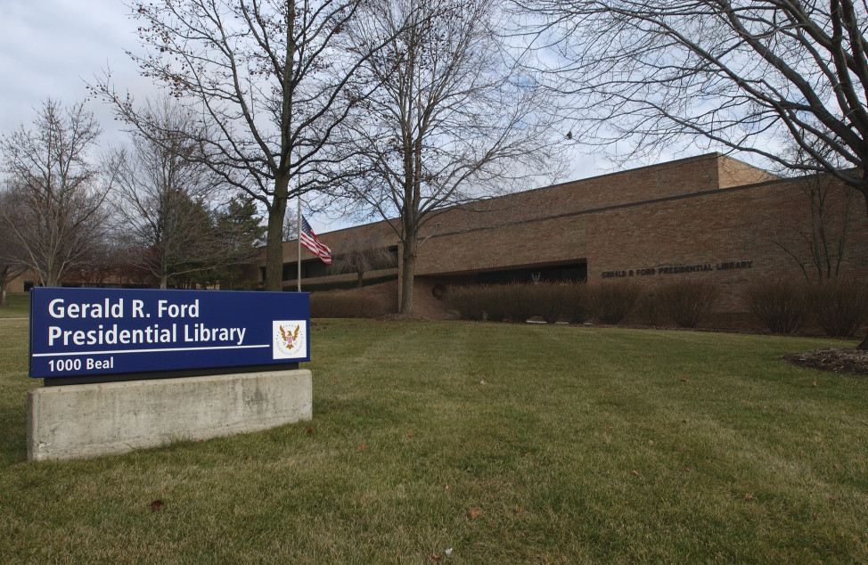 A flag flies at half staff outside the Gerald R. Ford Presidential Library at the University of Michigan campus in Ann Arbor, Michigan, Dec. 27, 2006, after the former president's death at age 93. (AP Photo)