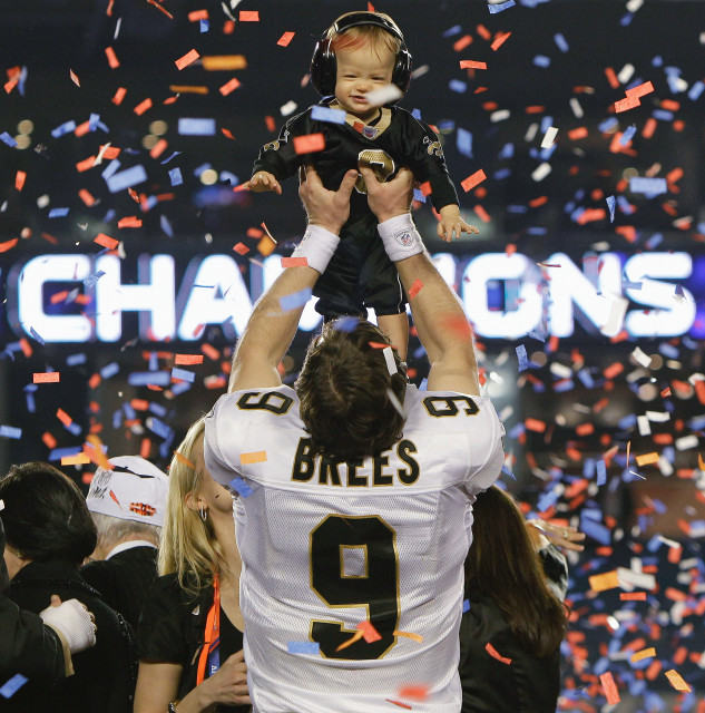 New Orleans Saints quarterback Drew Brees (9) holds his son Baylen after defeating the Indianapolis Colts 31-17 in Super Bowl XLIV, Feb. 7, 2010 , in Miami. (AP Photo)