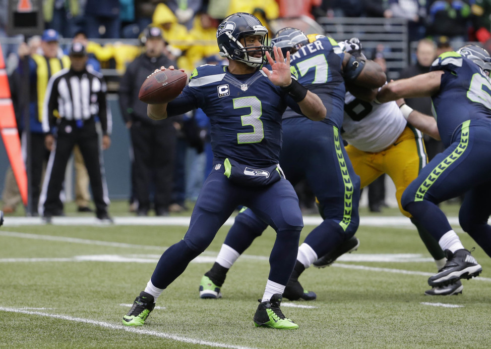 Seattle Seahawks quarterback Russell Wilson (3) credits God with his team's dramatic come-from-behind win to advance to the Super Bowl, the premiere event in American sports, Jan. 18, 2015 in Seattle. (AP Photo)  