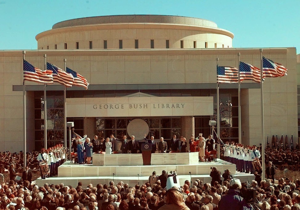 Former President George H.W. Bush, left, is joined by then President Clinton, former President Ford and former President Carter on the stage at the George H.W. Bush Presidential Library dedication in College Station, Texas, Nov. 6, 1997. (AP Photo)