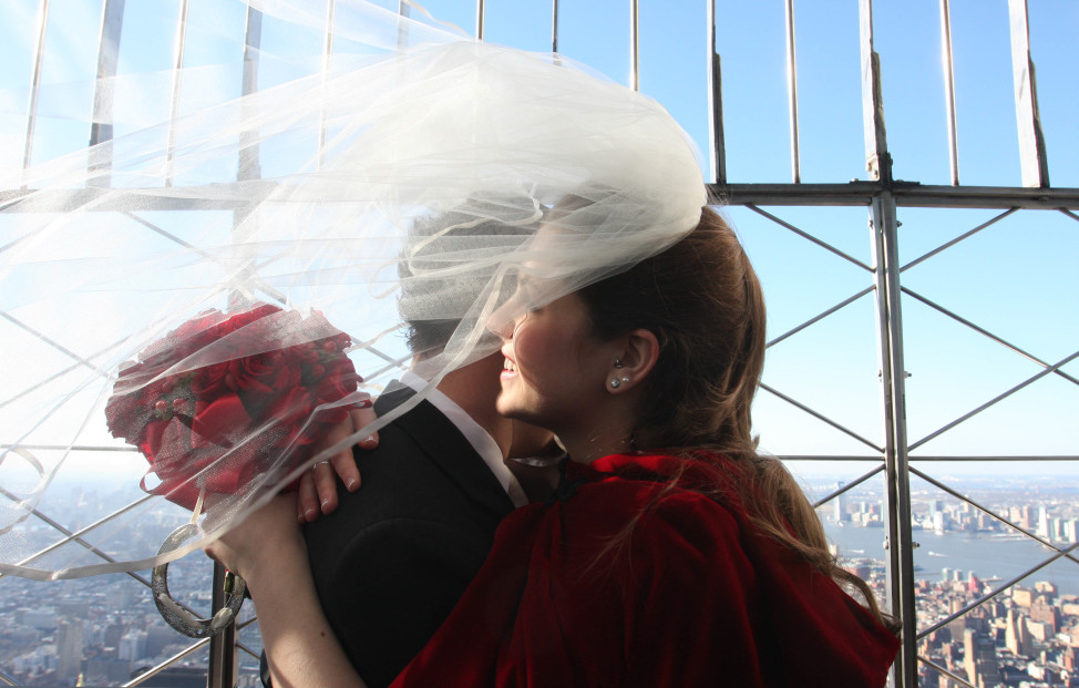 A couple shares a moment atop the Empire State Building after being married on Valentine's Day. (AP Photo)