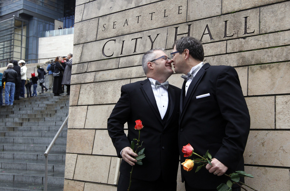 Terry Gilbert, left, kisses his husband Paul Beppler after wedding at Seattle City Hall, becoming among the first gay couples to legally wed in the state, Dec. 9, 2012, in Seattle, Washington. (AP Photo)