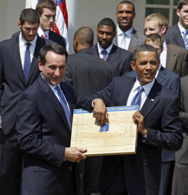 In this May 27, 2010 photo, President Barack Obama looks over the bracket with coach Mike Krzyzewski of the NCAA basketball champion Duke Blue Devils in the Rose Garden of the White House in Washington. (AP Photo) 
