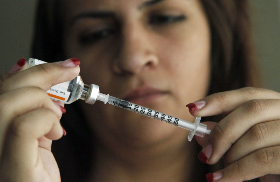Judith Garcia fills a syringe as she prepares to give herself an injection of insulin. (AP Photo)