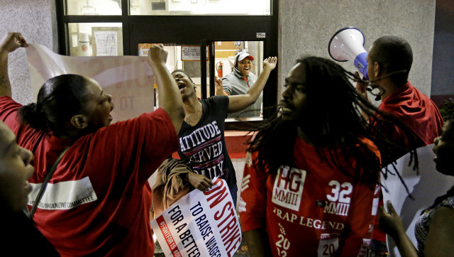 Workers protest at a Burger King restaurant in College Park, Georgia, calling for the federal minimum wage to be raised to $15, April 15, 2015. (AP Photo) 