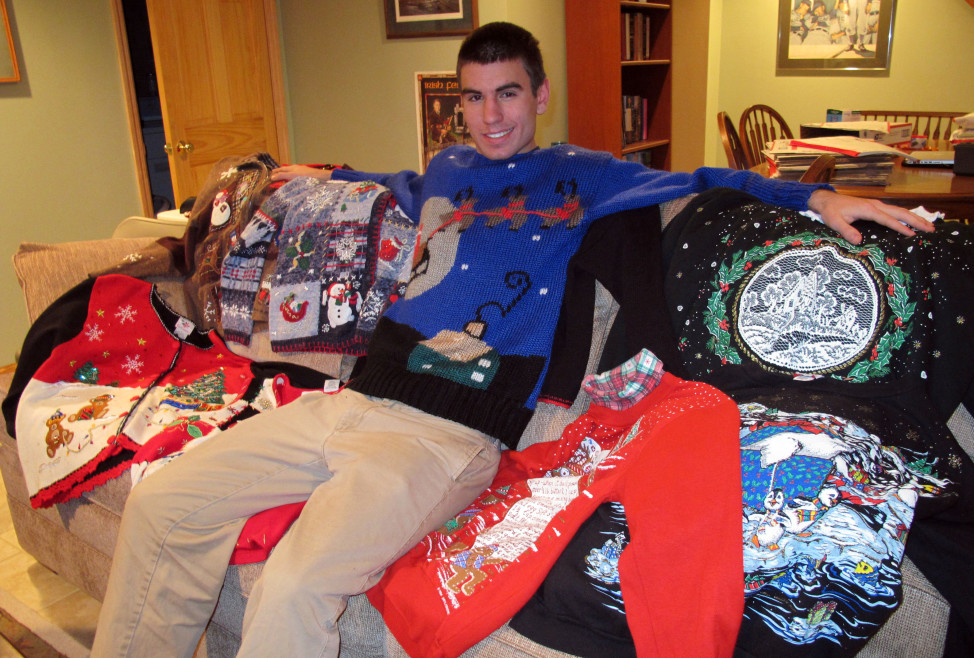 FILE – A young man poses with some sweaters in Wauwatosa, Wisconsin. (AP Photo)