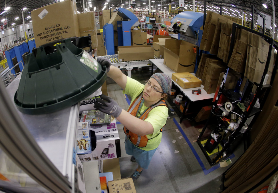 Ashley Merritt packs an order for shipping at a warehouse in Lebanon, Tenn. on Dec. 1, 2014. (AP Photo)