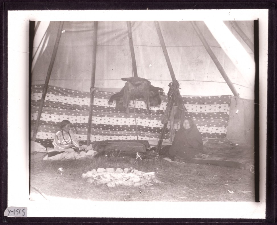 An original, unpainted image of two women inside a tipi.  photographer Walter McClintock (1870-1949) of the Blackfoot Indians of Montana. (Yale Collection of Western Americana, Beinecke Rare Book and Manuscript Library)