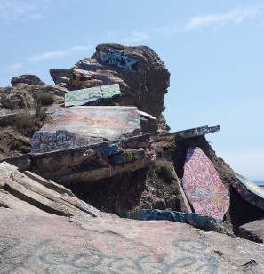 Graffiti adorns some of Sunken City’s cliffs and buckled roads, July 11, 2015. (Photo by Flickr user Jon May via Creative Commons license)