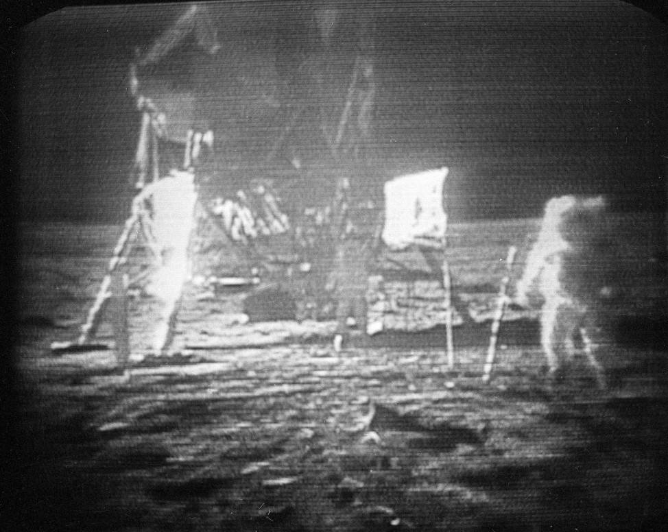 FILE - In this July 20, 1969 black-and-white file photo, taken from a television monitor, Apollo 11 astronaut Neil Armstrong, right, trudging across the surface of the moon.  Edwin E. Aldrin is seen closer to the craft. (AP Photo)