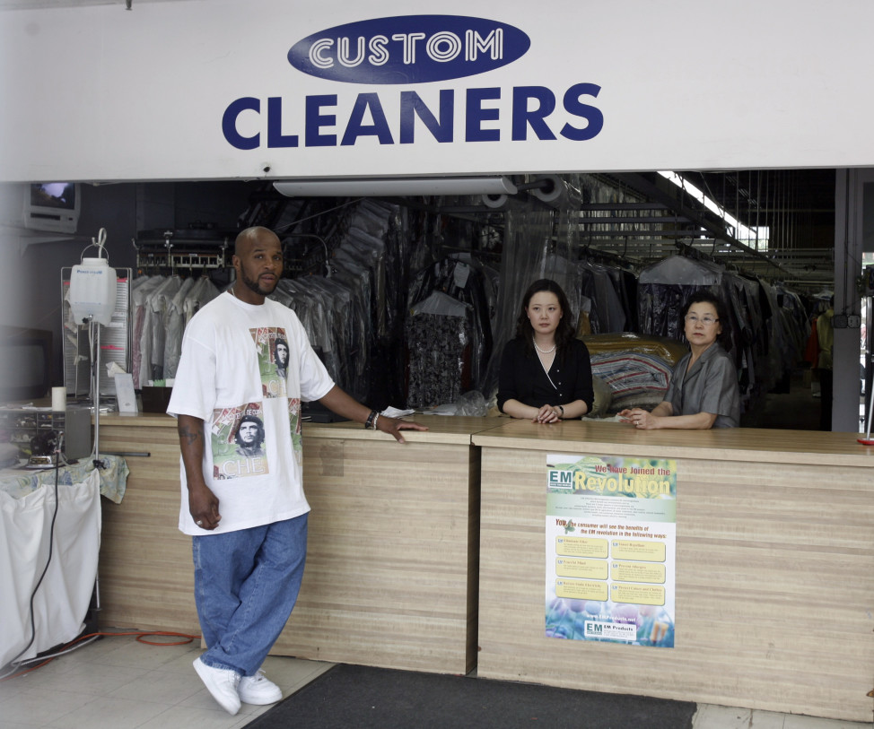 (File) Korean immigrant-owned Custom Dry Cleaners with store co-owner Chung Soo (R) and her daughter-in-law Choi Soo (C) behind the counter, with local customer Victory Hucks (L) in Washington, D.C. (Reuters)
