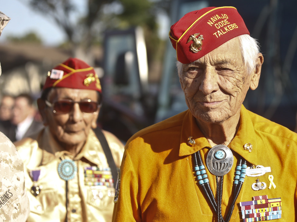 Former United States Marine and Navajo Code Talker Roy Hawthorne, right, leads fellow Marine and Navajo Code Talker Sam Holiday at a ceremony honoring the Navajo contribution to the World War II, Sept. 28, 2015, at Camp Pendleton, Calif.  (AP Photo)