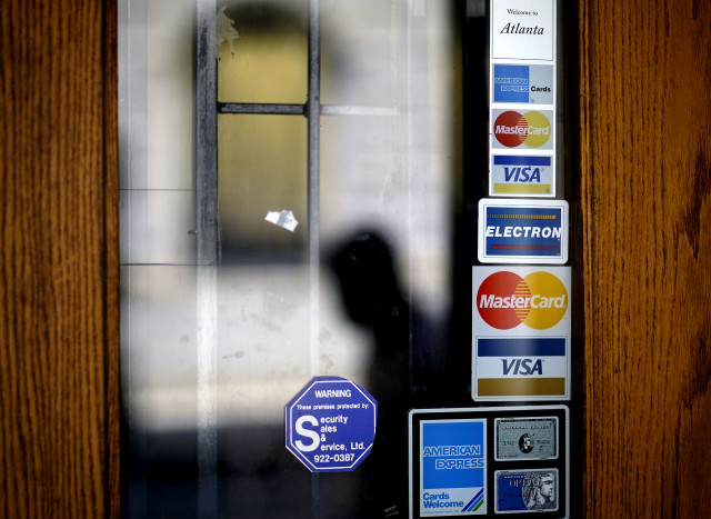 On average, Americans carry $15,000 in credit card debt. (AP File Photo) 