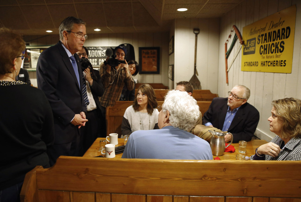 Republican presidential candidate Jeb Bush, left, speaks with potential voters at a restaurant in Urbandale, Iowa, Jan. 13, 2016. (AP Photo