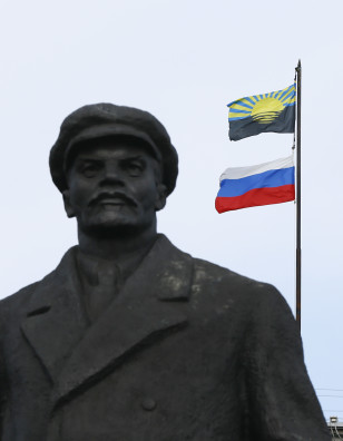 View shows statue of Soviet state founder Lenin in front of the mayor's office, with flags of Russia and Donetsk region erected on the roof, in Slaviansk