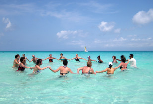 Tourists exercise in the water at the Santa Maria Key Resort in central Cuba