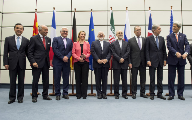 Ministers and officials pose for a group picture at the United Nations building in Vienna