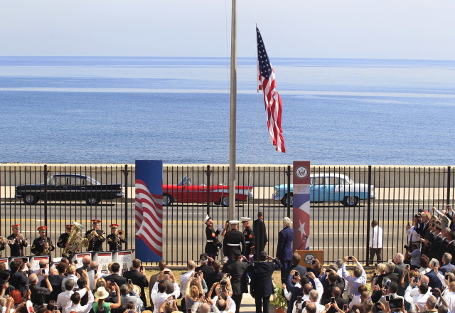 U.S. marines raise the U.S. flag while watched over by U.S. Secretary of State John Kerry at the U.S. embassy in Havana