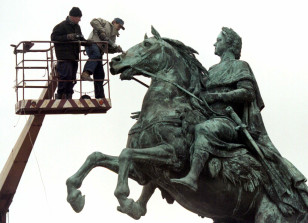 Workers clean a monument to Peter the Great, the founder of St. Petersburg May 6. The city is prepar..