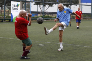 Senior soccer players take part in a match at a soccer field in Miraflores