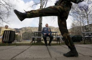 World War Two veteran Samokhin watches honour guard marching at war memorial in Divnogorsk