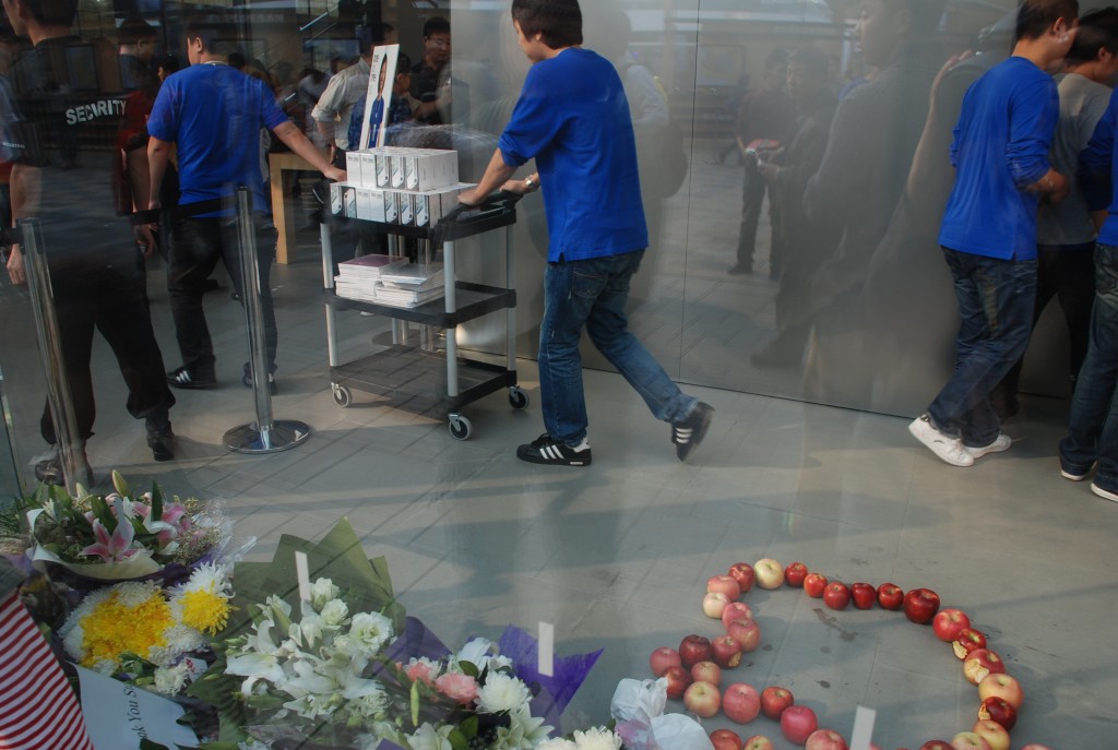 Workers at the Apple store in Beijing wheel out new iPhone 4s