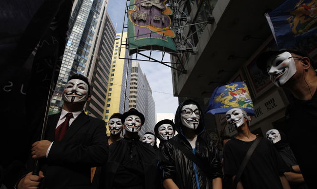 Protesters wearing masks take to the streets to appeal for people to join them for an upcoming protest in Hong Kong