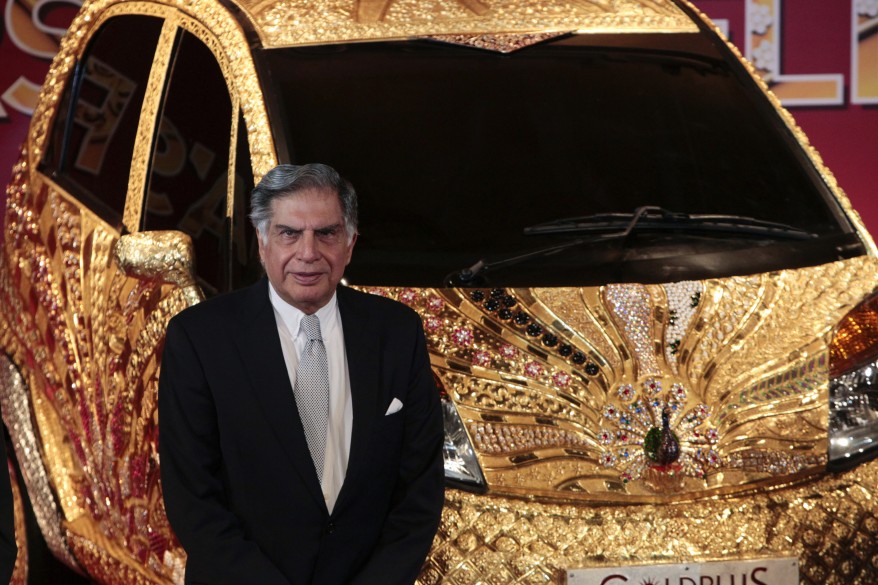 Chairman of Tata Group Ratan Tata poses in front of a Nano car made of gold during a ceremony in Mumbai (Reuters)