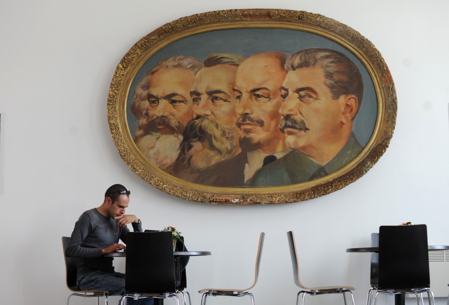 A man works on his laptop in the cafe of the Museum of Socialist Art in Sofia, Bulgaria, after the opening ceremony. Twenty-two years after the fall of its communist regime, Bulgaria opened on Monday its first-ever museum of the state-sponsored, propaganda art characteristic of that era. The Museum exhibited some 77 monumental sculptures, 60 paintings and 25 smaller plastic art works created between 1945 and 1989 by the most renowned sculptors and painters of the time. (AFP)