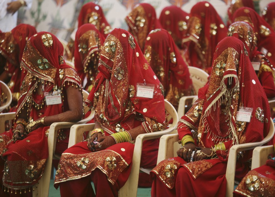 6Brides wait for the start of their mass marriage ceremony in the western