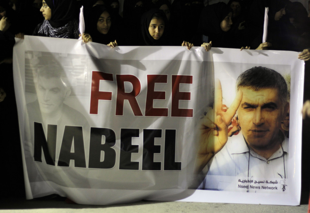 Supporters of jailed Baharini human rights activist Nabeel Rajab hold up a banner demanding his freedom Sunday, May 6, 2012, in the northwestern village of Bani Jamra, Bahrain. AP