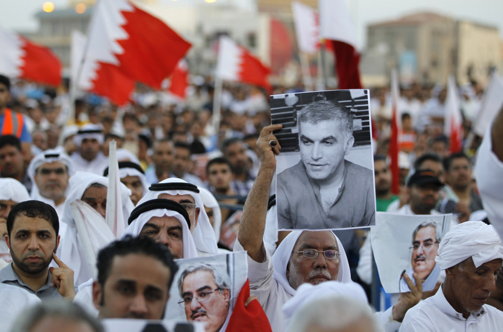An anti-government protester holds a picture of Nabeel Rajab, founder of the Bahrain Centre for Human Rights, during a sit-in organized by Bahrain's main opposition party Al Wefaq, at the village of Muqsha, west of Manama, September 20, 2013. REUTERS/Hamad I Mohammed 