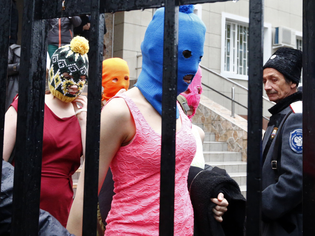 Masked members of protest band Pussy Riot leave a police station in Adler during the 2014 Sochi Winter Olympics, February 18, 2014. Two members of Pussy Riot, Maria Alyokhina and Nadezhda Tolokonnikova were detained on Tuesday in connection with a theft in the Winter Olympics host city of Sochi, less than two months after their release from prison under an amnesty.         REUTERS/Shamil Zhumatov 