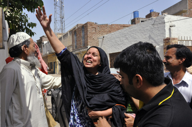 A woman reacts to the killing of Rashid Rehman, a lawyer who was shot by unidentified gunmen a day earlier, outside his residence in Multan May 8, 2014. Gunmen posing as clients shot dead the prominent human rights lawyer defending a professor accused of blasphemy, officials said Thursday, underscoring the danger facing those trying to put an end to religious intolerance in majority-Muslim Pakistan. Wednesday's killing of Rashid Rehman in the southern city Multan was the first time a lawyer has been killed for taking on a blasphemy case, police said. REUTERS/Stringer