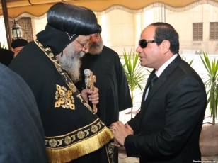 Egyptian President Abdel-Fattah el-Sissi, right, offers his condolences to Egypt's Coptic Pope Tawadros II at Saint-Mark's Coptic Cathedral in Cairo's al-Abbassiya district, Feb. 16, 2015. 