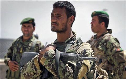 kabul afghanistan 2011. An Afghan soldier cradles his