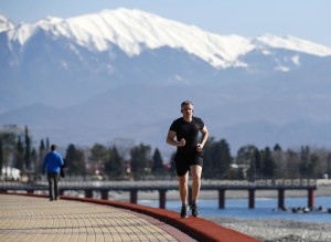 It may be healthy, but it is not cold. Man jogs on coast near Olympic Park. Photo: Reuters/Shamil Zhurnatov