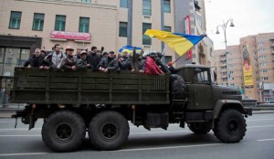 Russia's nightmare: Rebels ride atop a confiscated military truck in central Kyiv on Feb. 22. Will they next head East to confront Yanukovych supporters? AP Photo: Darko Bandic