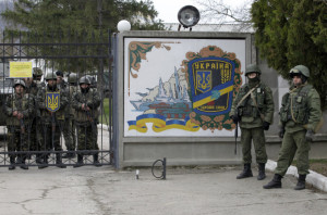 Ukrainian soldiers wait inside the gates of their base Perevolnoye, Crimea, which was surrounded Sunday by 400 Russian soldiers and four Russian armored personnel carriers. Photo:AP/Darko Vojinovic