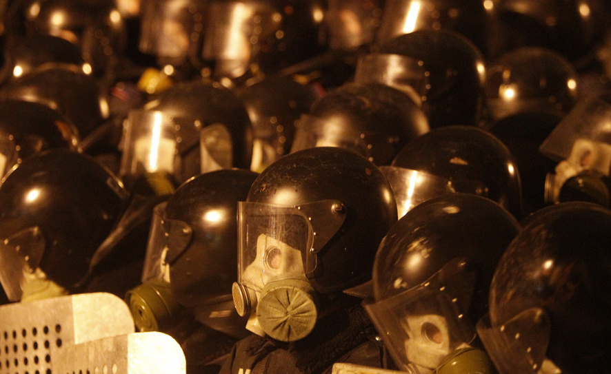 Interior Ministry members and riot policemen stand guard during a rally held by supporters of EU integration in Kiev