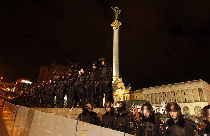 Riot police stand guard at Independence Square during a protest in Kiev