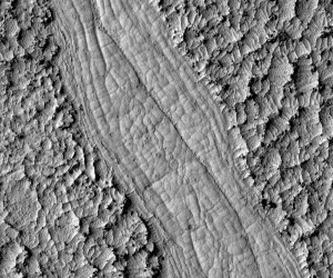 Newer lava lying between two older plates of rough, hardened lava was still hot and plastic enough to form coils and spirals when the plates slid past one another. This image shows an area about 360 meters wide in Cerberus Palus. - click on for bigger image - (Photo: NASA/JPL/University of Arizona)