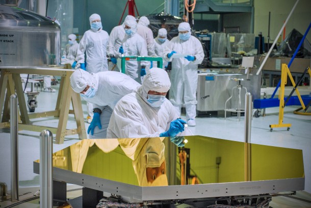 Technicians and scientists, in the clean room at NASA's Goddard Space Flight Center in Greenbelt, Md., check out one of the first two flight mirrors that will be used on the new Webb Space Telescope. (Photo: NASA/Chris Gunn)