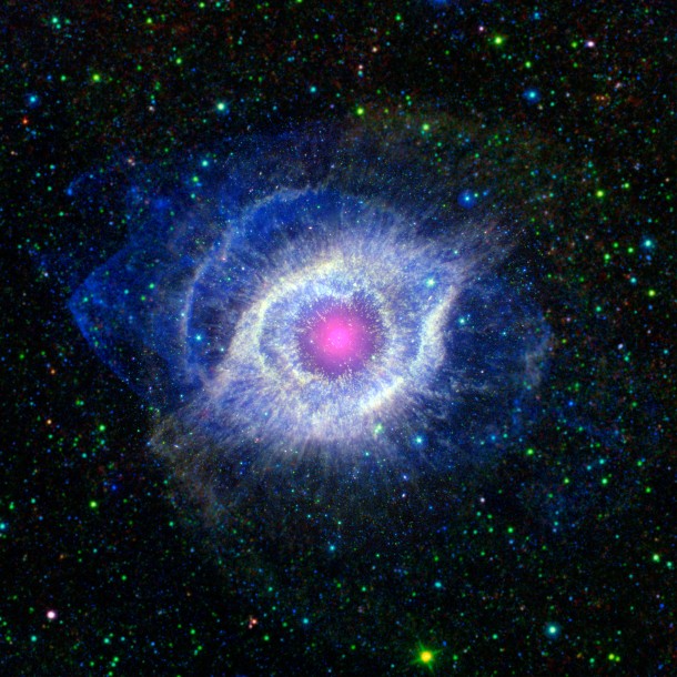 In a combined image from NASA's Spitzer Space Telescope, the Galaxy Evolution Explorer (GALEX) and the Wide-field Infrared Survey Explorer (WISE), this is the Helix Nebula, which has also been called the “Eye of God.”  At the nebula's heart is a dying star.  In its death throes, the star's outer layers unravel into space and is set aglow by powerful ultraviolet radiation that's being pumped out by it's hot stellar core. (Photo: NASA)