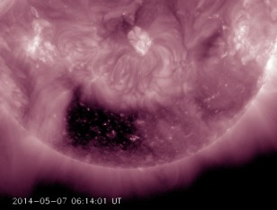 A coronal hole, almost square in its shape, is one of the most noticeable features on the Sun of May 5-7, 2014. Because it is positioned so far south on the Sun, there is less chance that the solar wind stream will impact us here on Earth. (Solar Dynamics Observatory/NASA)