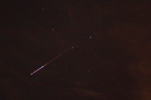A meteor from the August 2009 Perseid meteor shower flashes across the Texas night sky. (Jared Tennant via Wikimedia Commons)